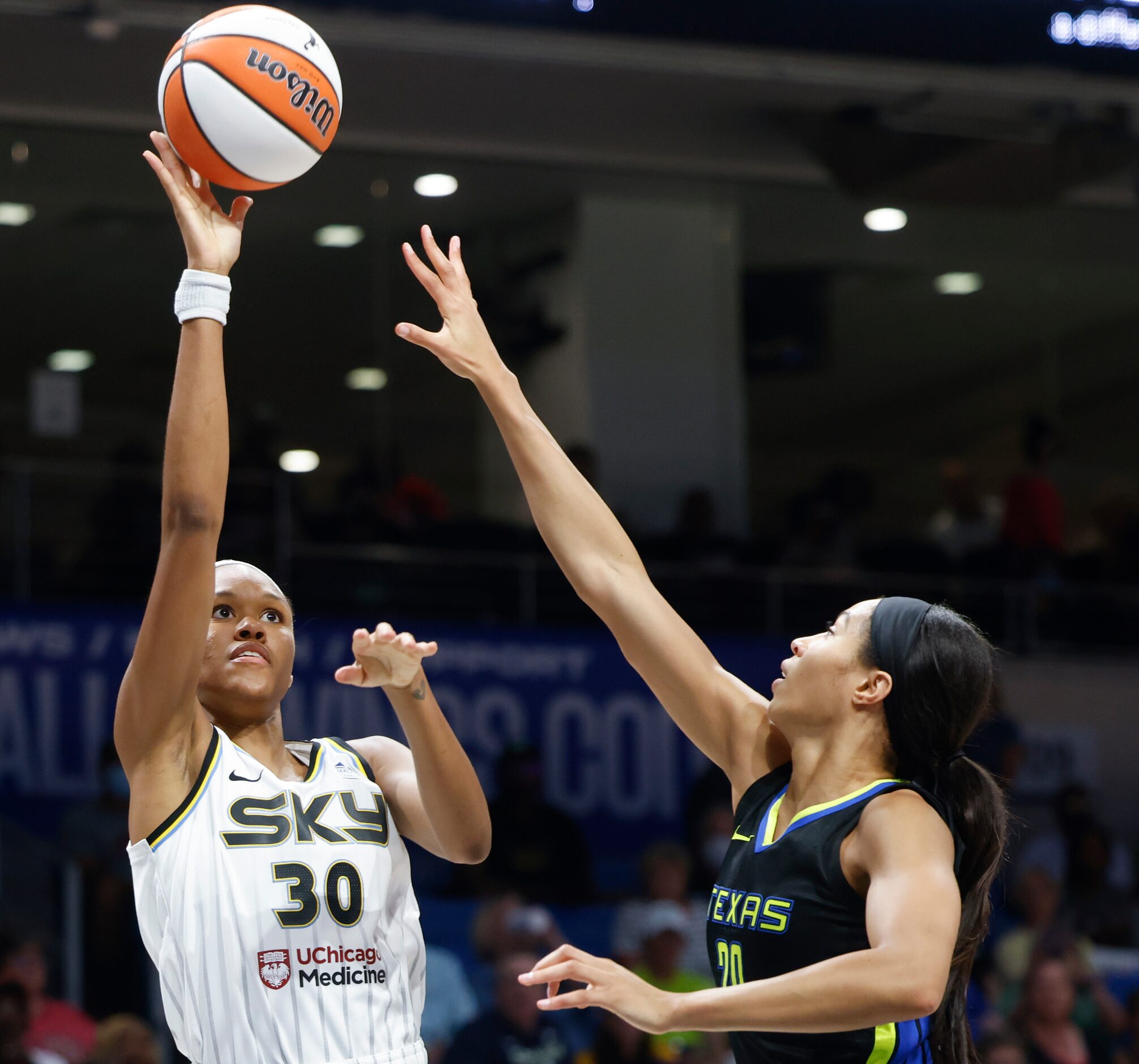 Chicago Sky forward Azura Stevens, left, shoots as Dallas Wings forward Isabelle Harrison...