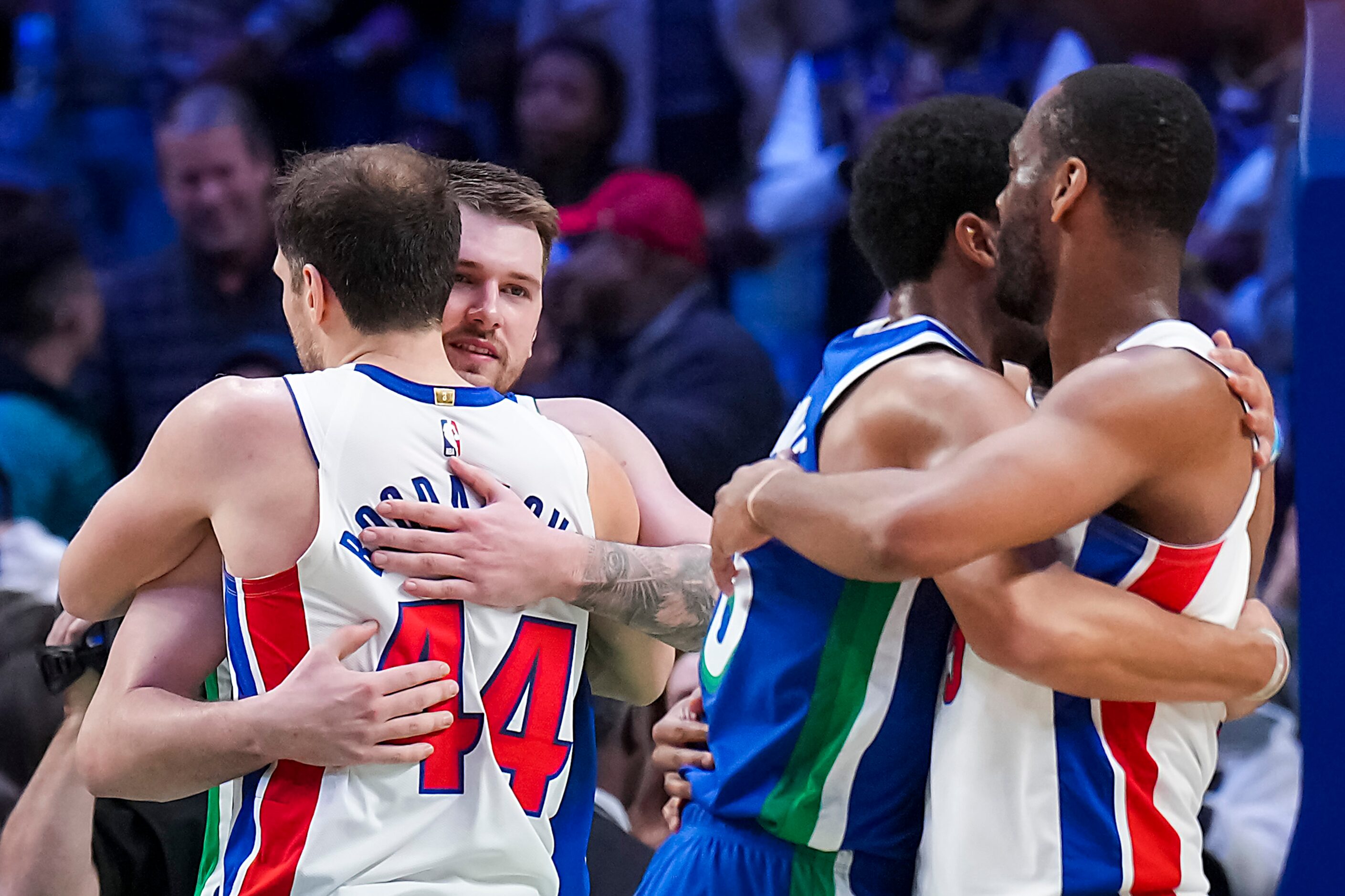 Dallas Mavericks guard Luka Doncic (77) hugs Detroit Pistons forward Bojan Bogdanovic (44)...