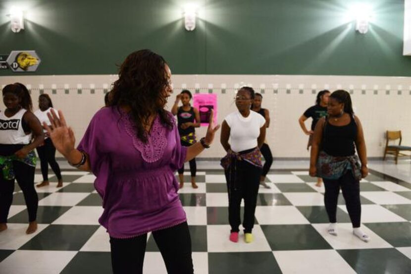 
Berkner chemistry teacher Adaobi Umeaku demonstrates a dance move to members of the Berkner...