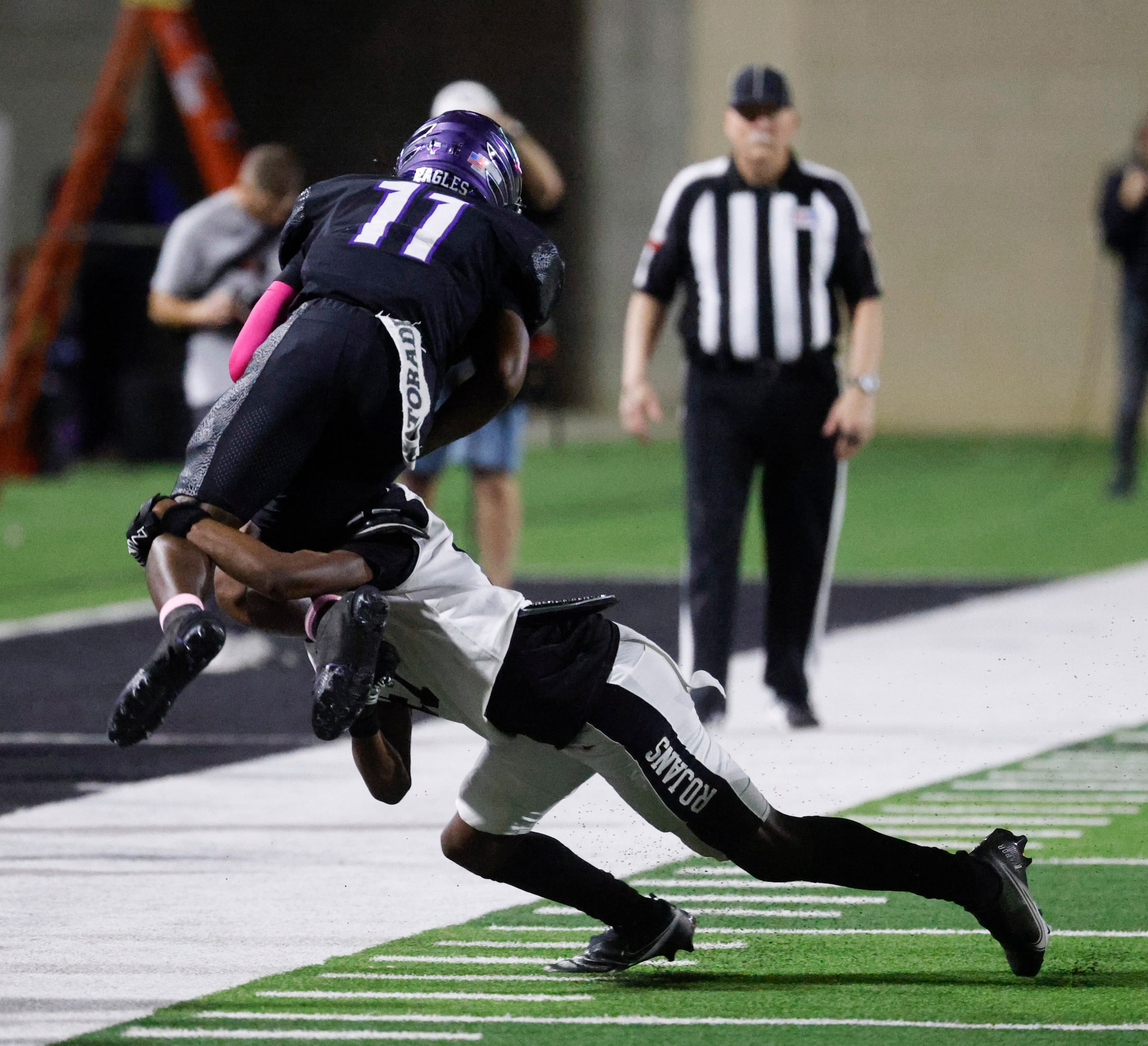 Crowley high’s Curtis Johnson (11) jumps as he is tackled by Trinity High’s Harrison Smith...