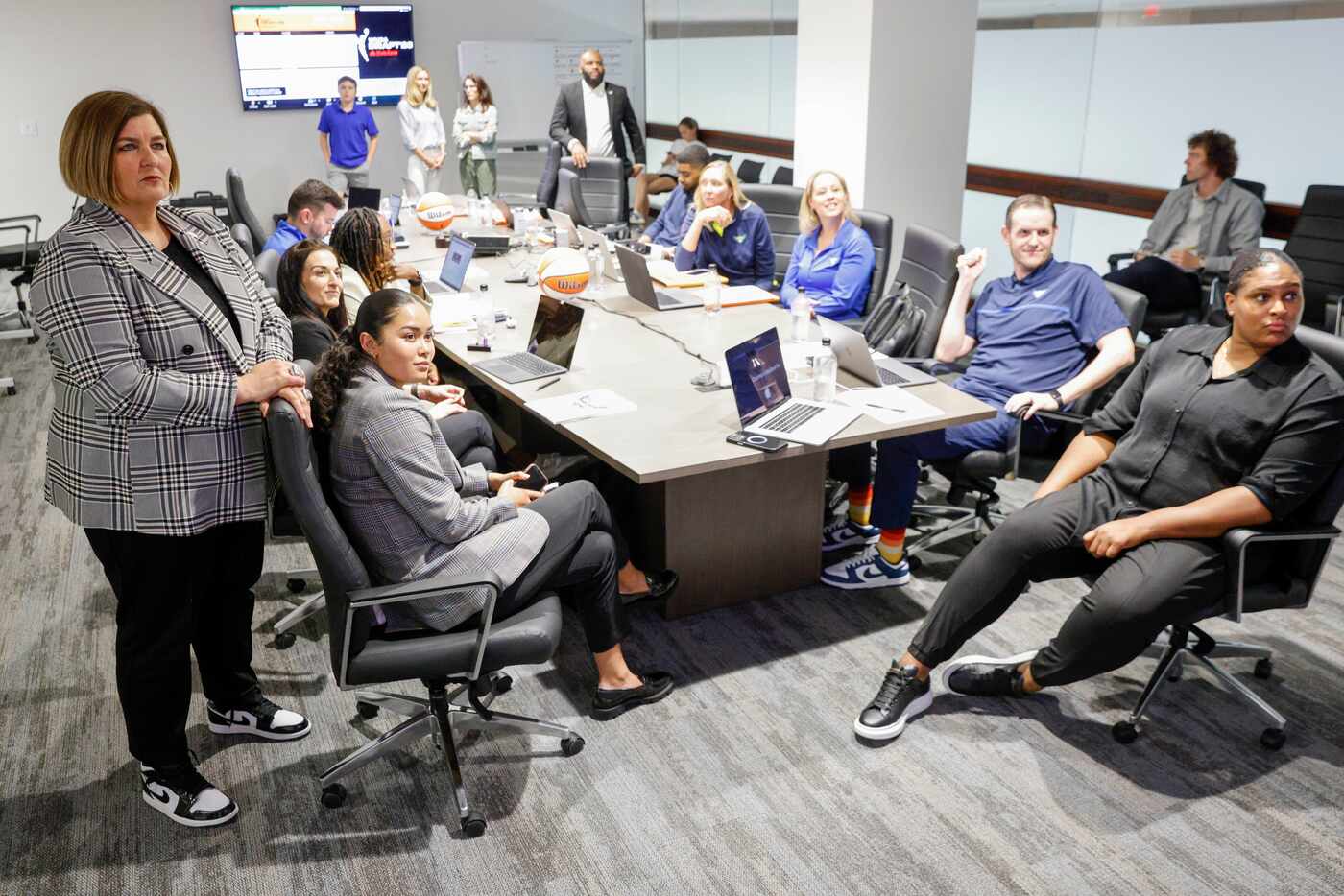 Dallas Wings head coach Latricia Trammell (left) watches coverage of the 2023 WNBA draft...