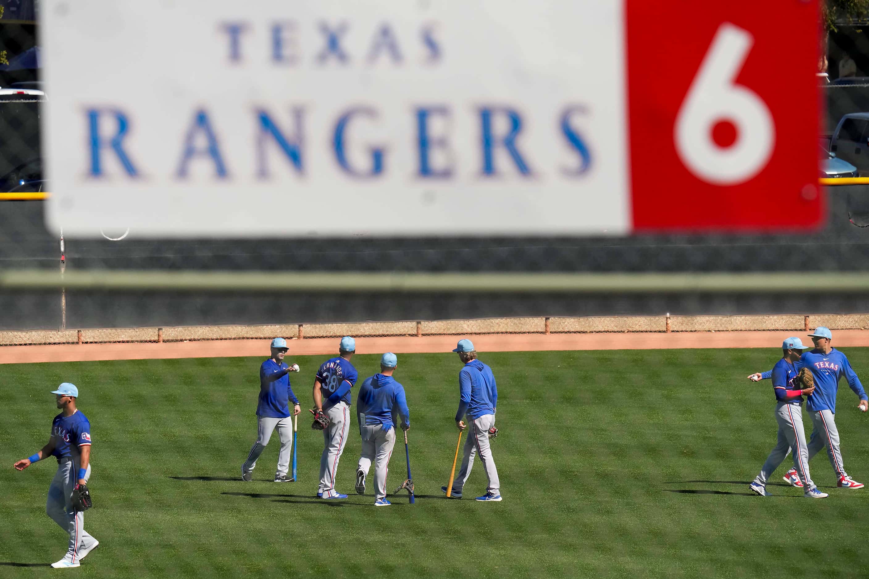 Texas Rangers outfielders work on a practice field during the first full squad spring...