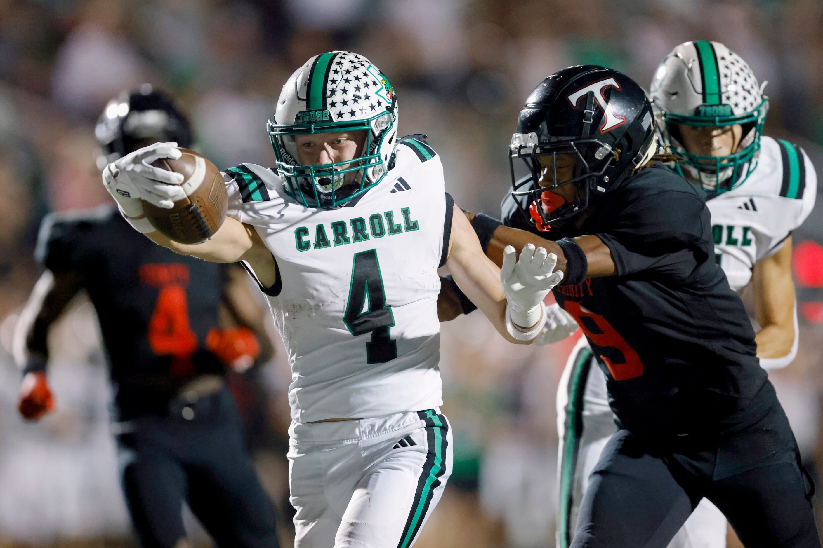 Southlake Carroll wide receiver Luc Jacquemard (4) stretches the ball across the goal line...