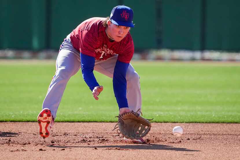 Infielder Cameron Cauley fields a grounder during a Texas Rangers minor league spring camp...