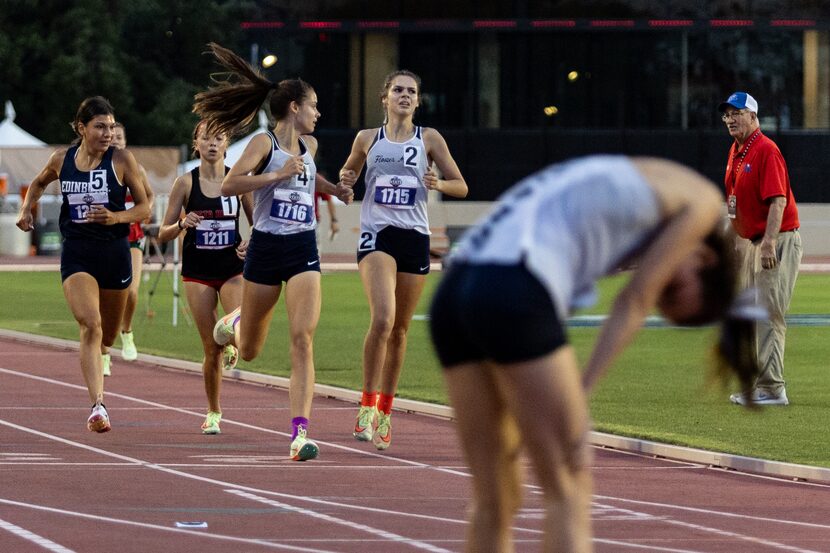 Twins Samantha Humphries and Nicole Humphries of Flower Mound cross the finish line for...