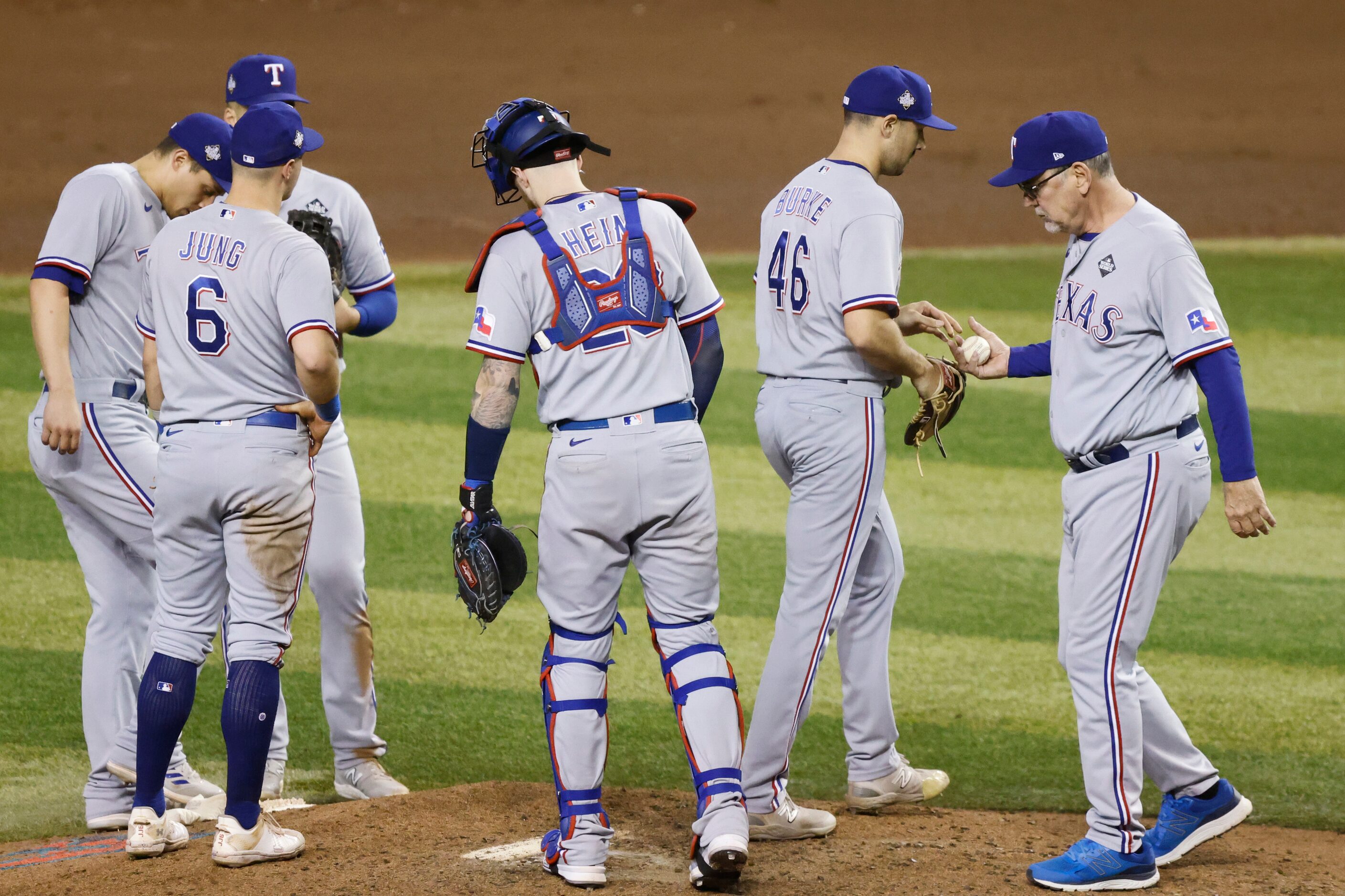 Texas Rangers manager Bruce Bochy, right, relieves relief pitcher Brock Burke (46) during...