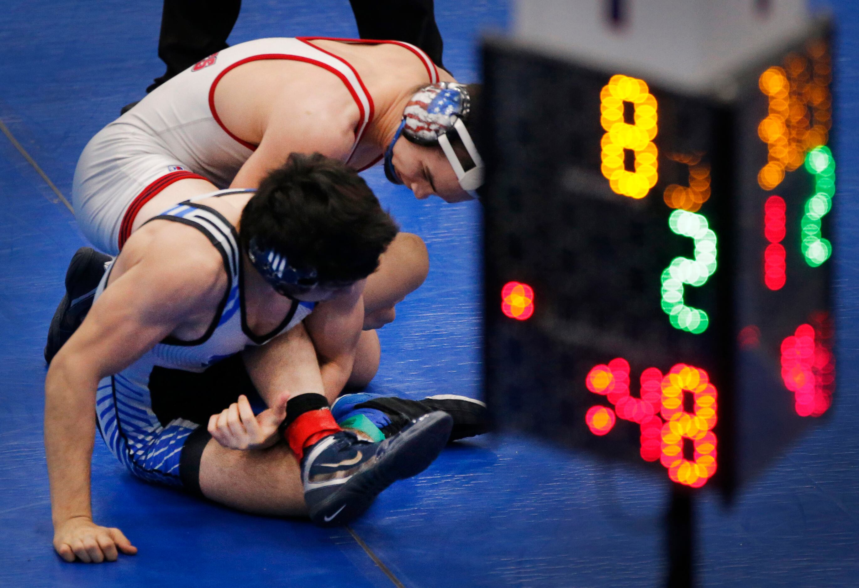 Allen High wrestler Mario Danzi (top) to free himself from Plano West's Jacob Aragon during...