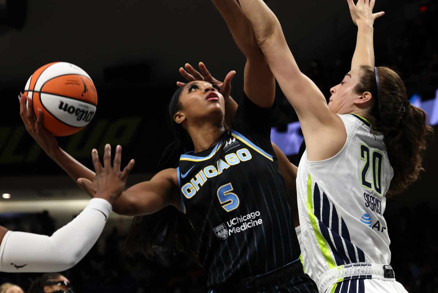 Chicago Sky forward  Angel Reese (5) left, shoots against the defense of Dallas Wings...