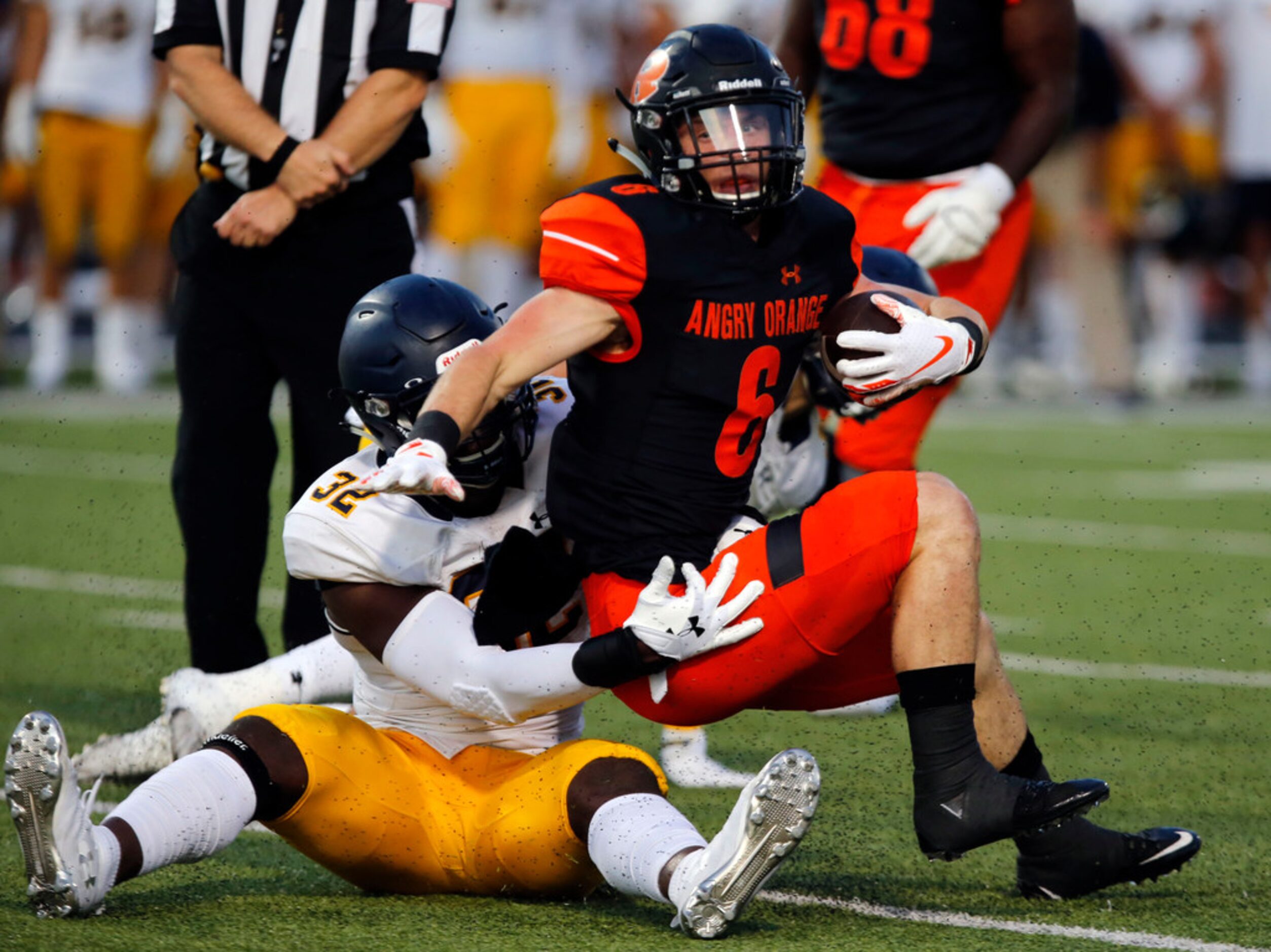 Highland Park defender Prince Dorbah (32) stops Rockwall RB Zach Henry (6) during the first...