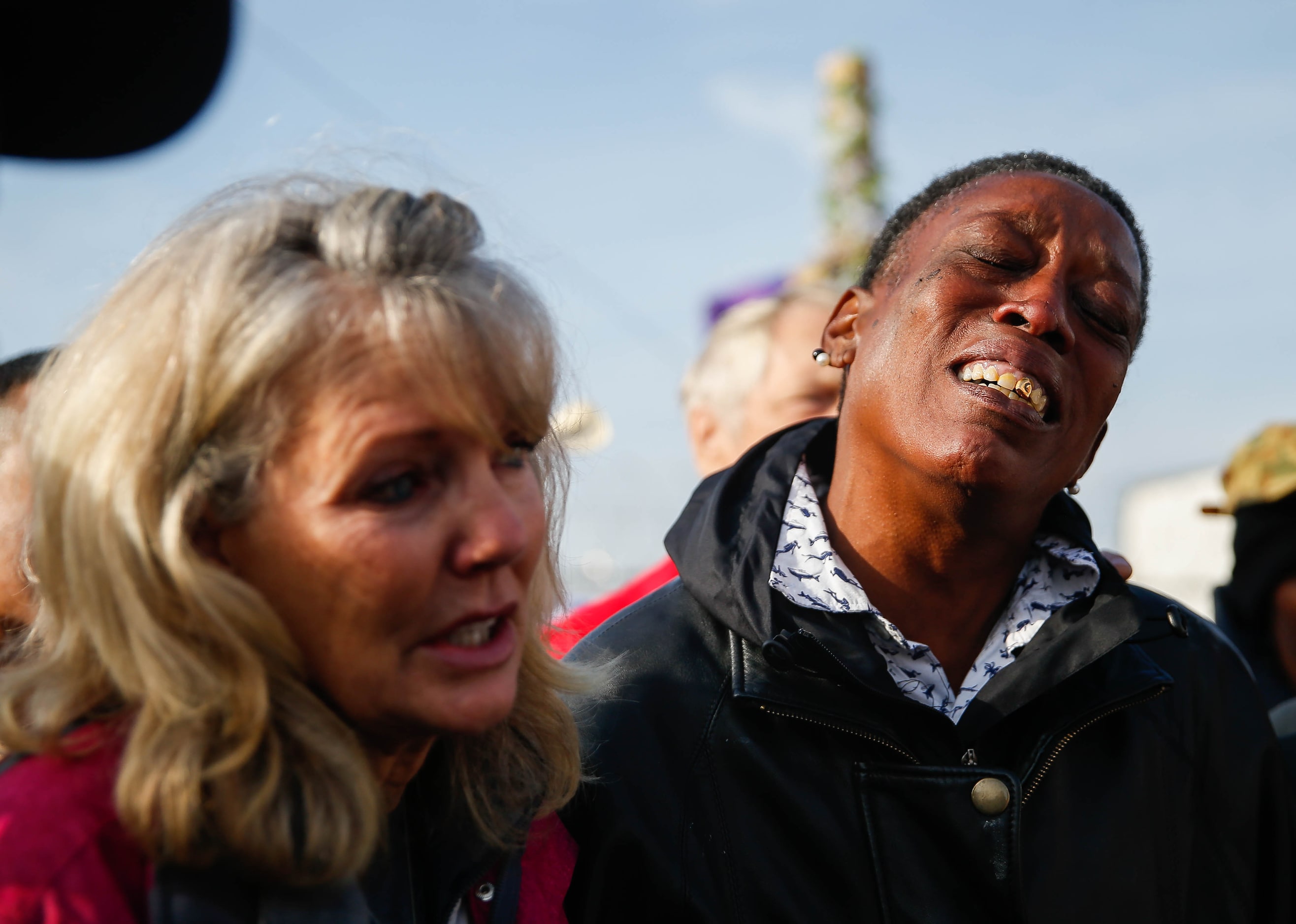 Rhonda Carrington (right) and Jennifer Birdd cried during Pastor Jeffery Parker's speech...