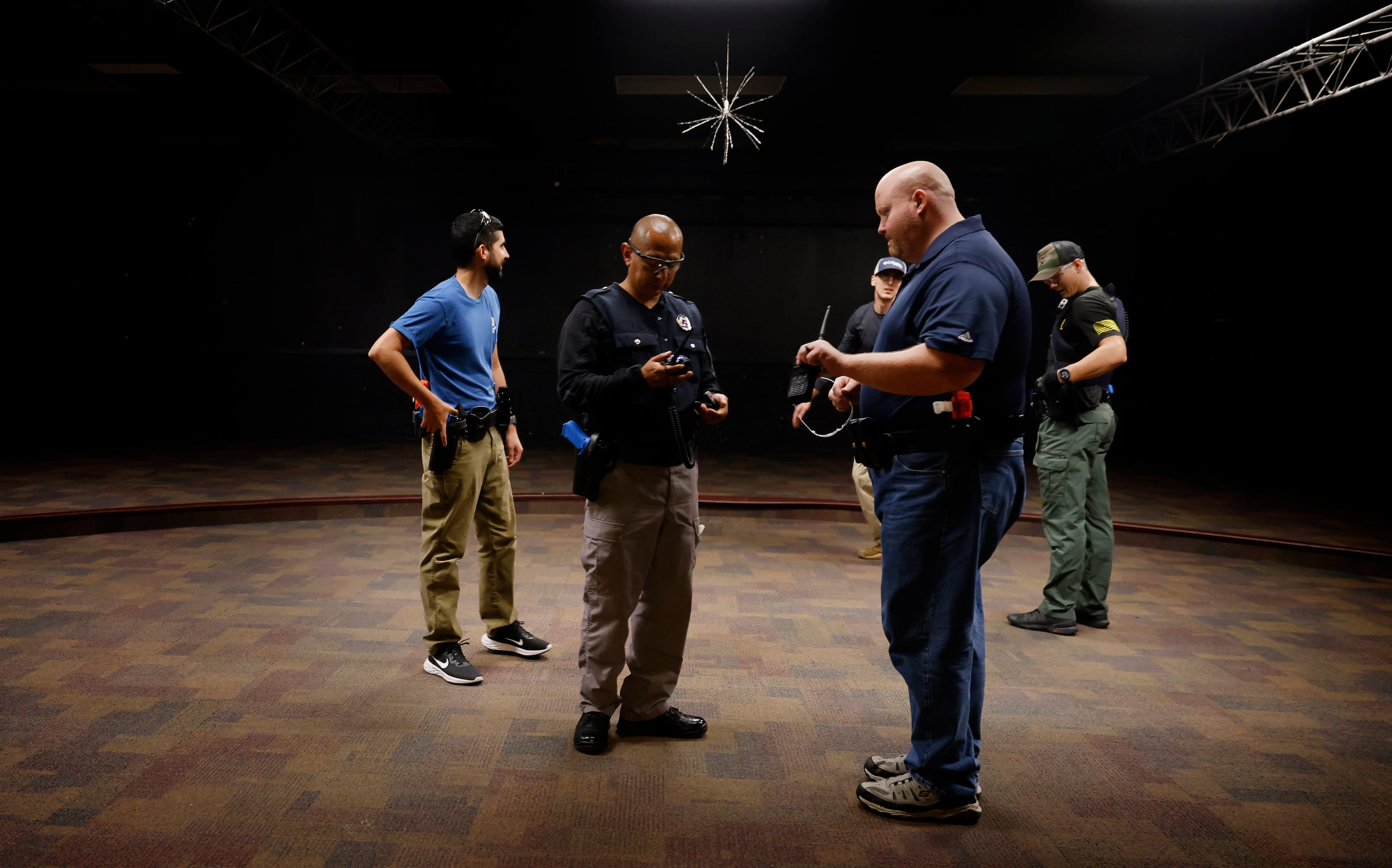 Athens Police Officers Rodolfo De La Cruz (front left) and Roger Keith (front right) work...