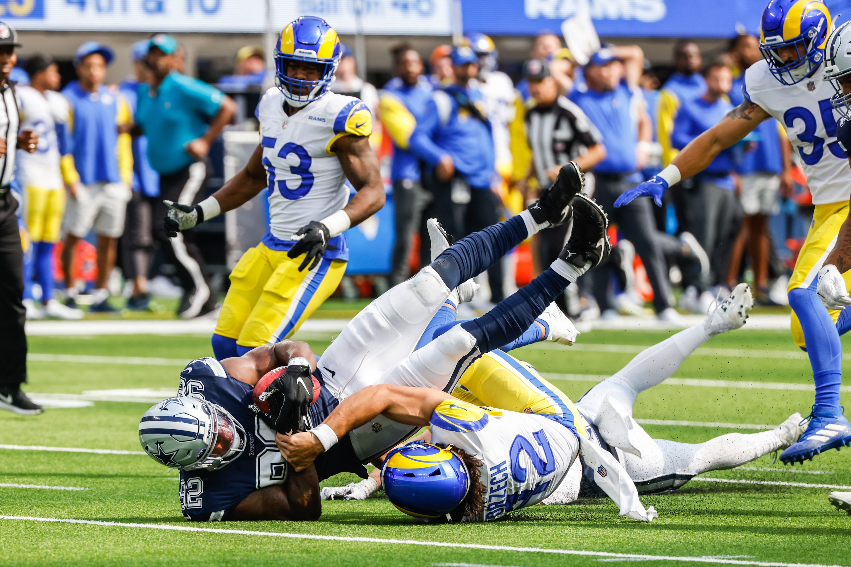 Dallas Cowboys defensive end Dorance Armstrong (92) scoops up the ball past Los Angeles Rams...