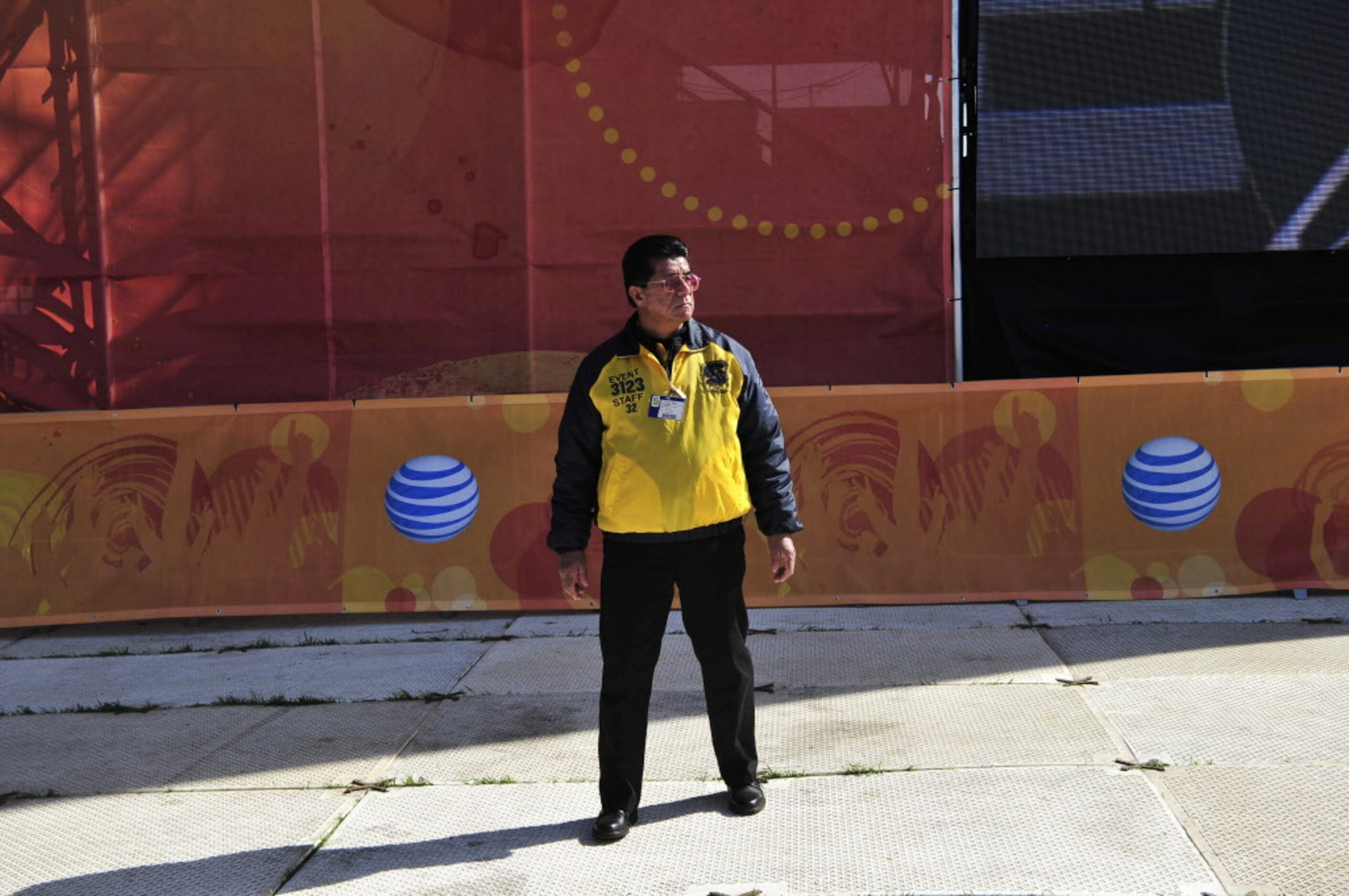 Event Staff worker Lorenzo Marquez stands watch near the stage at the 2014 NCAA March...