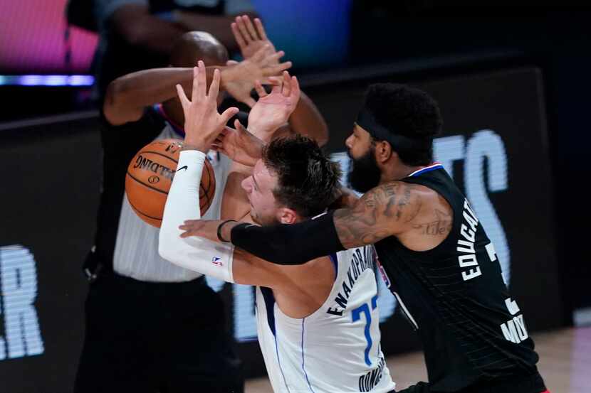 In this Aug. 30, 2020, file photo, Dallas Mavericks' Luka Doncic (77) is fouled by Los...