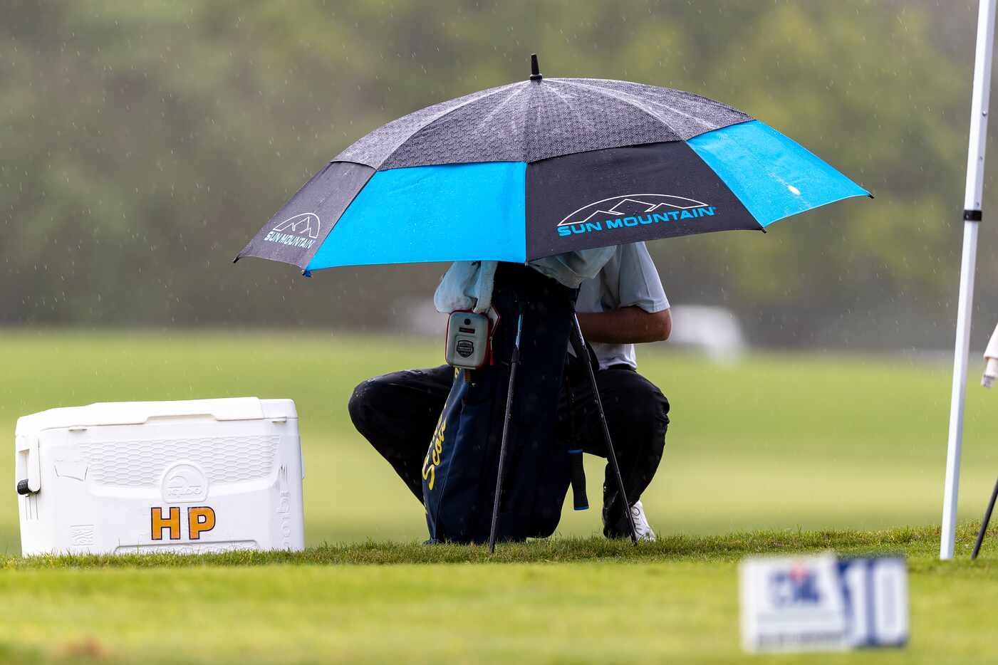 Highland ParkÕs Thompson Huthnance prepares to play in the rain on the 10th tee box during...