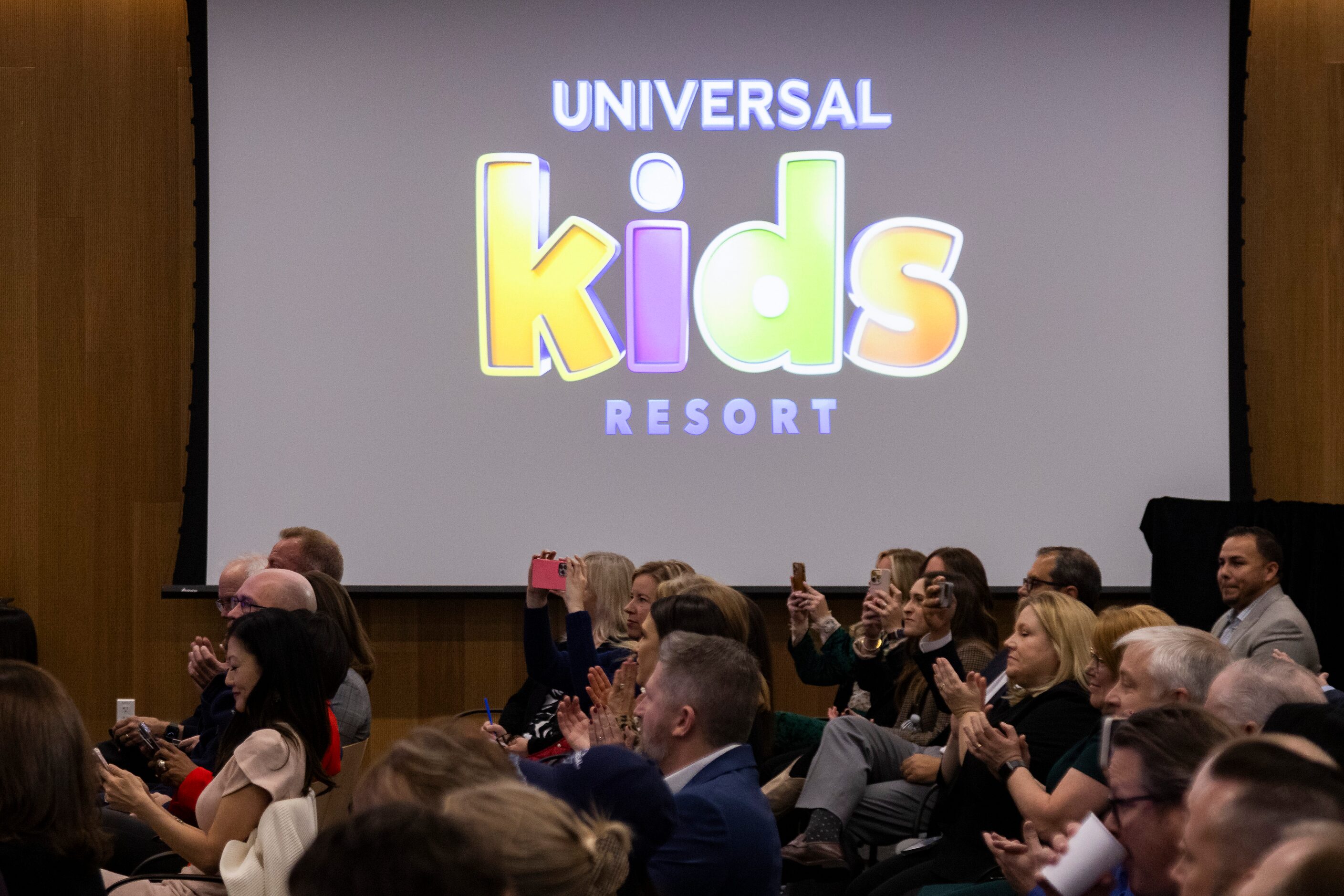 People clap as Mark Woodbury, chairman and CEO of Universal Destinations & Experiences,...