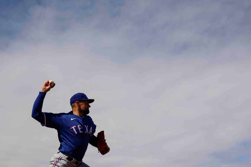 Texas Rangers pitcher Nathan Eovaldi throws a pitch during a spring training workout at the...