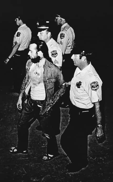 In this Friday, July 22, 1972 file photo, Milwaukee Police officers lead comedian George...