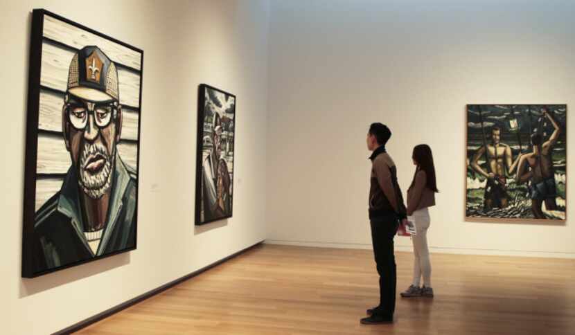 Jayson Oh, left, and Meri Park of Dallas look at the work of Dallas artist David Bates on...