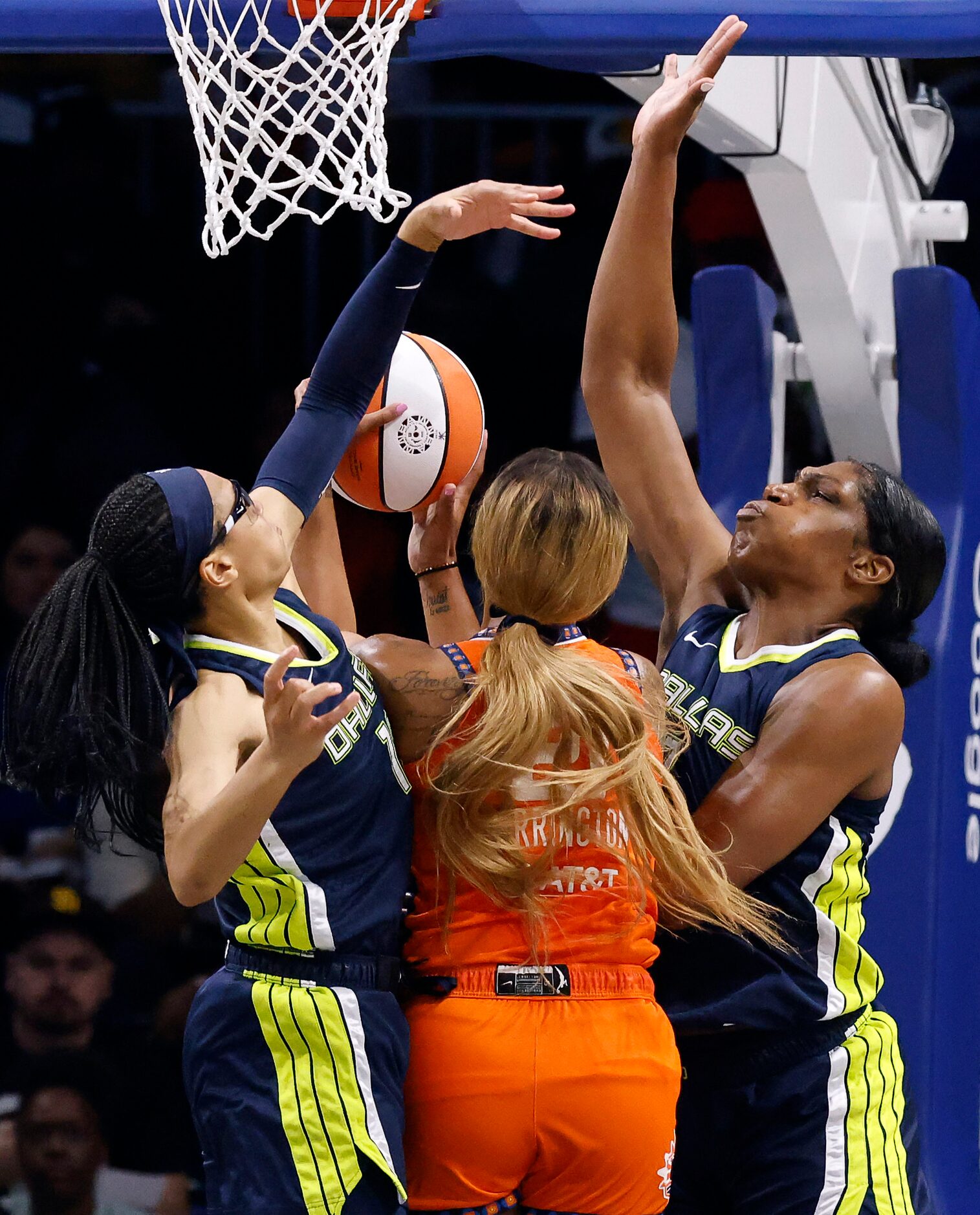 Dallas Wings guard Allisha Gray (15) and center Teaira McCowan (7) block a shot by...