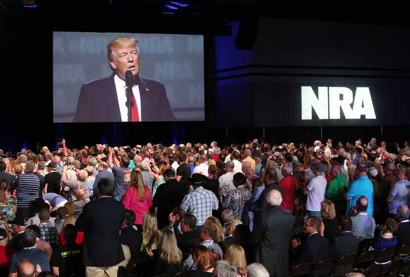 Thousands of NRA attendees watch the keynote by President Donald J. Trump on one of the...