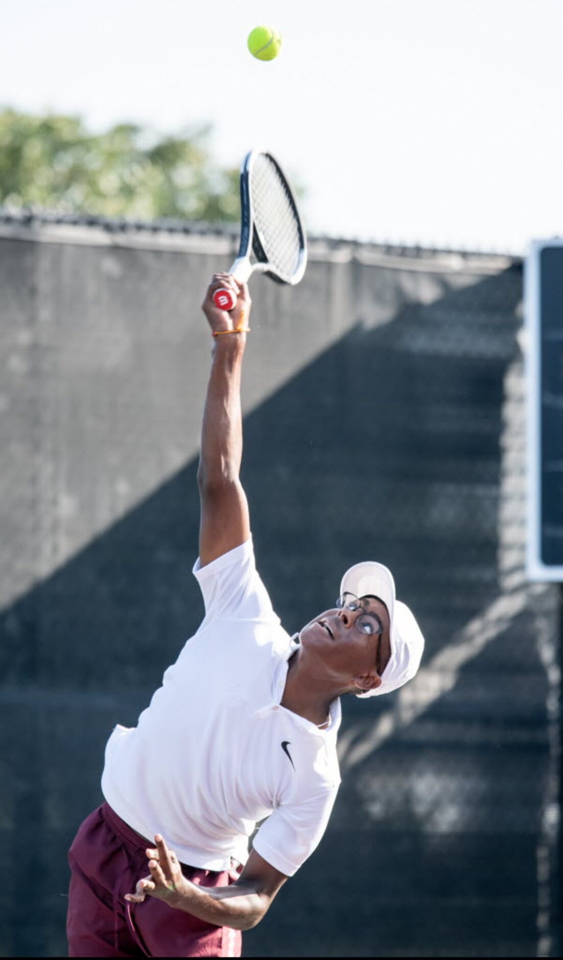 Red Oak's Jerod Wilson serves the ball in a singles match against Northside Harlan's Landon...