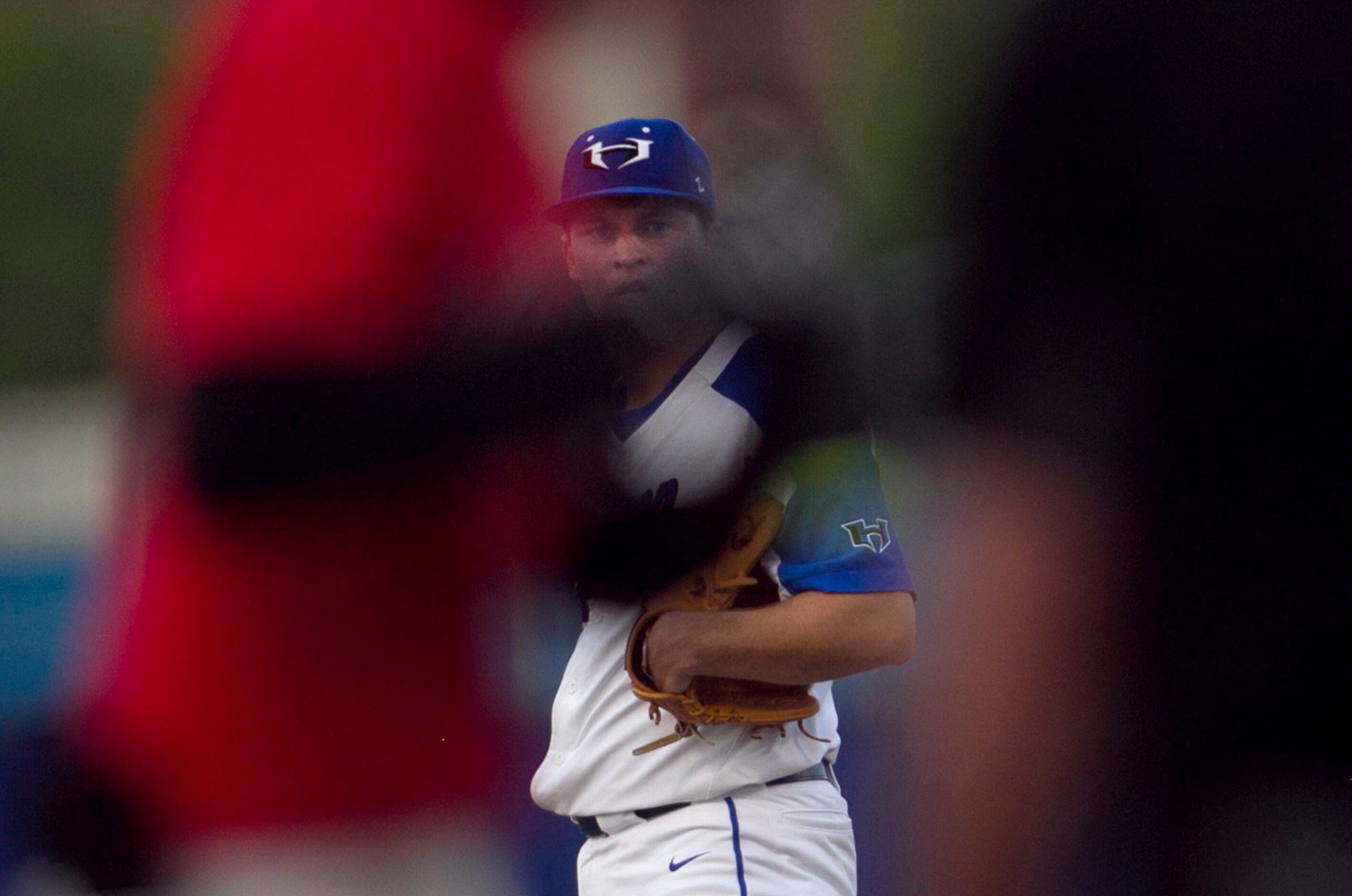 Hebron pitcher Jeremy Slate (2) studies the signs from his catcher between pitches to a...