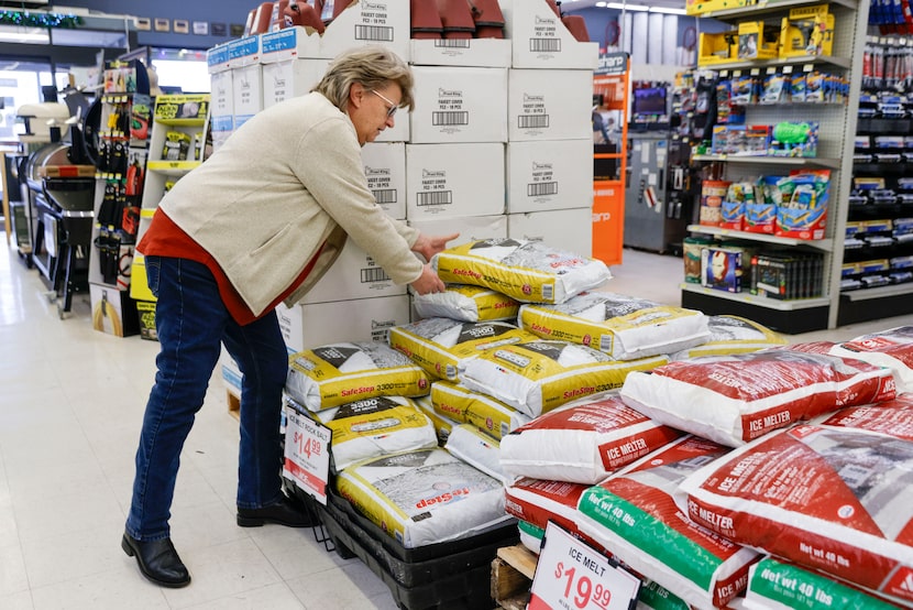 Michelle Emory grabs a bag of ice melter off a pallet at Jabo's Ace Hardware, Wednesday,...