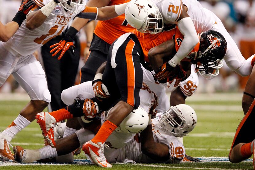 Oregon State Beavers running back Storm Woods (24) is tackled by Texas Longhorns safety...