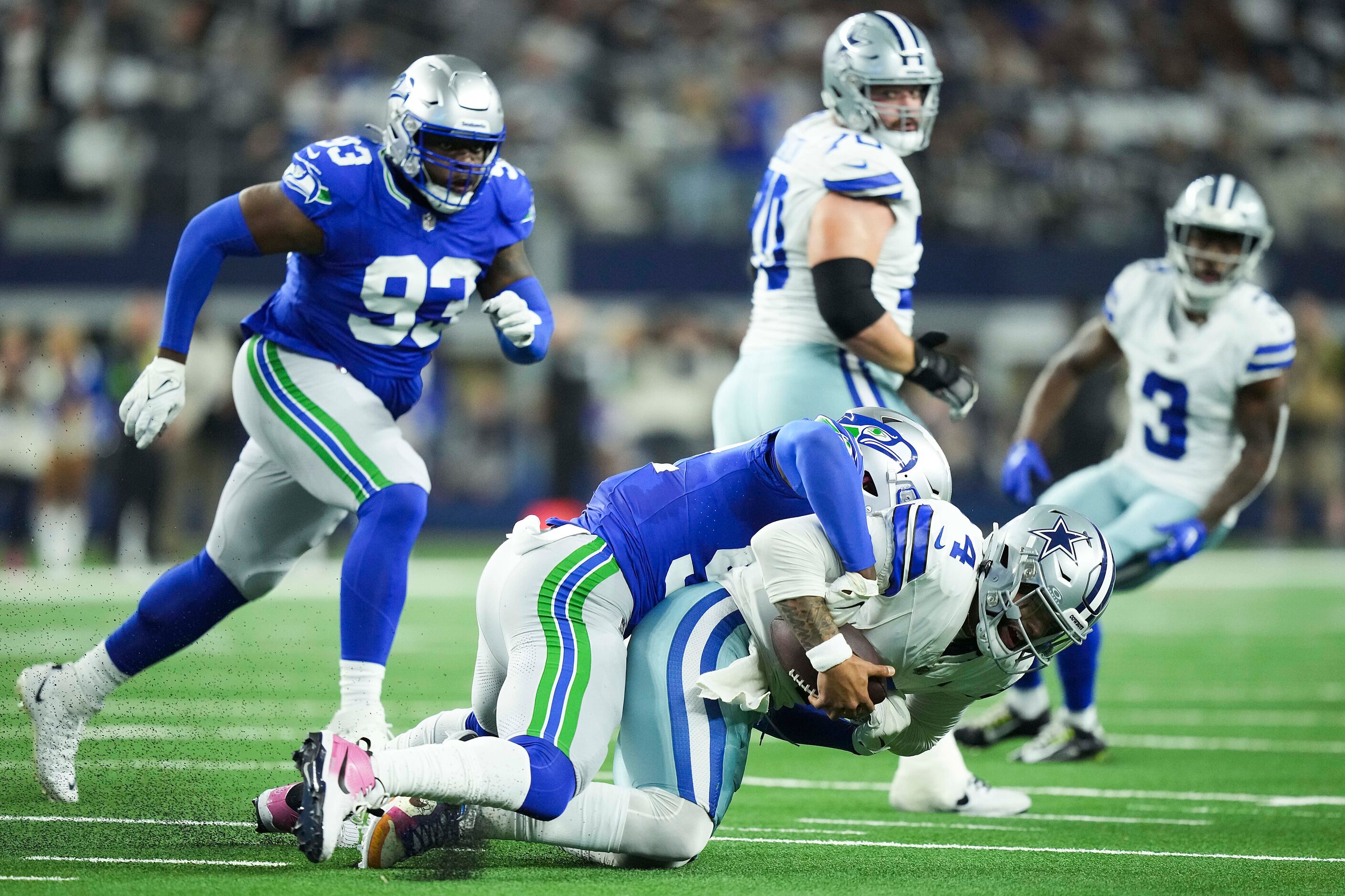 Dallas Cowboys quarterback Dak Prescott (4) is sacked by Seattle Seahawks linebacker Darrell...