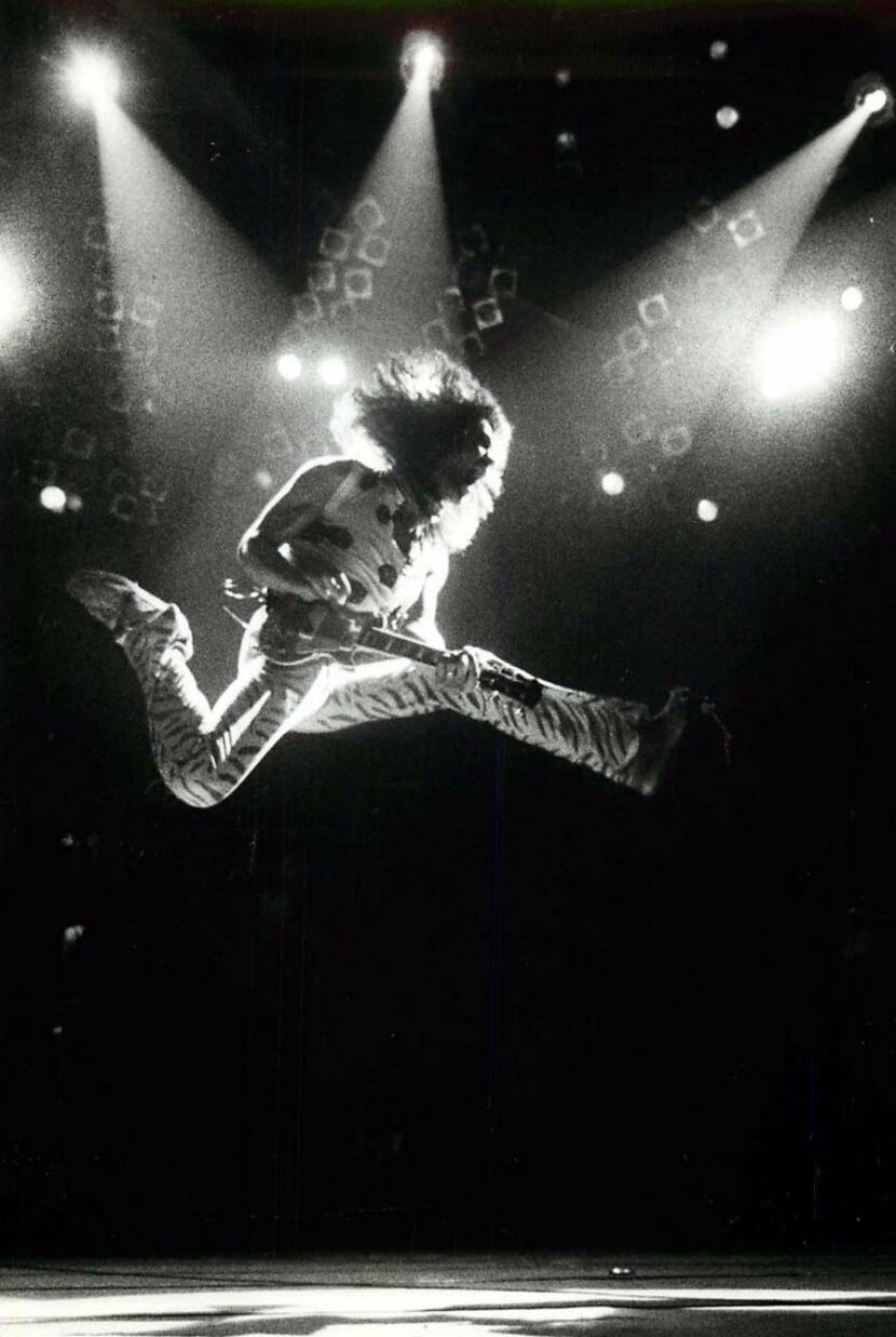 Eddie Van Halen leaps into the air for the Reunion Arena crowd in July 1984