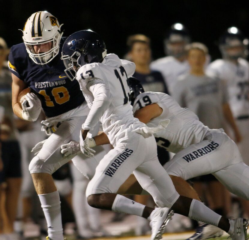 Prestonwood Christian receiver Austin Stogner (18) tacks on extra yardage as Argyle...