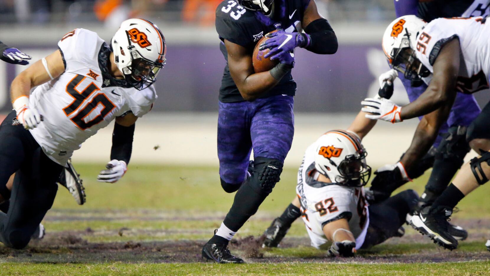 TCU Horned Frogs running back Sewo Olonilua (33) finds a hole in the Oklahoma State Cowboys...