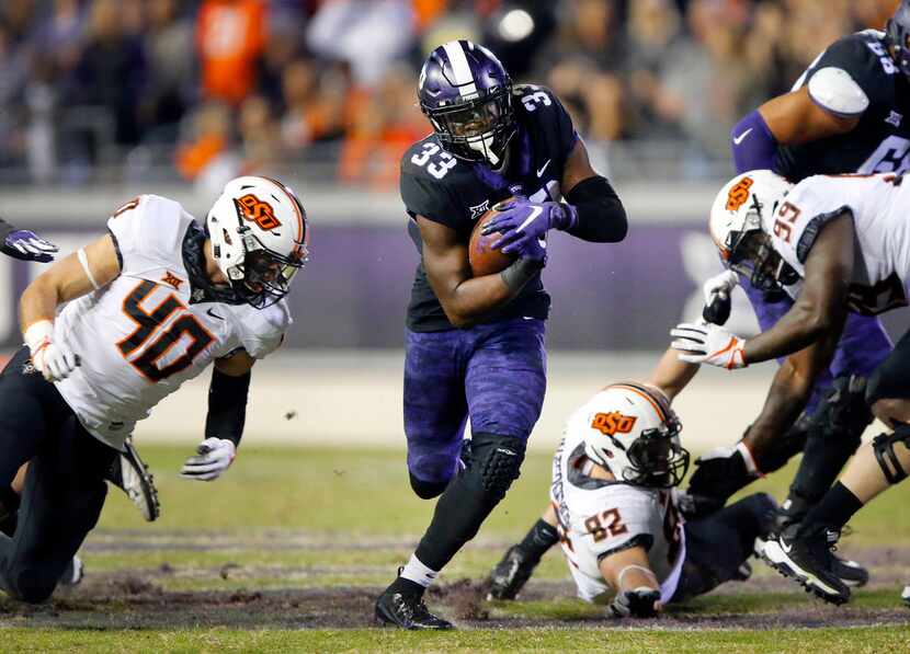 TCU Horned Frogs running back Sewo Olonilua (33) finds a hole in the Oklahoma State Cowboys...