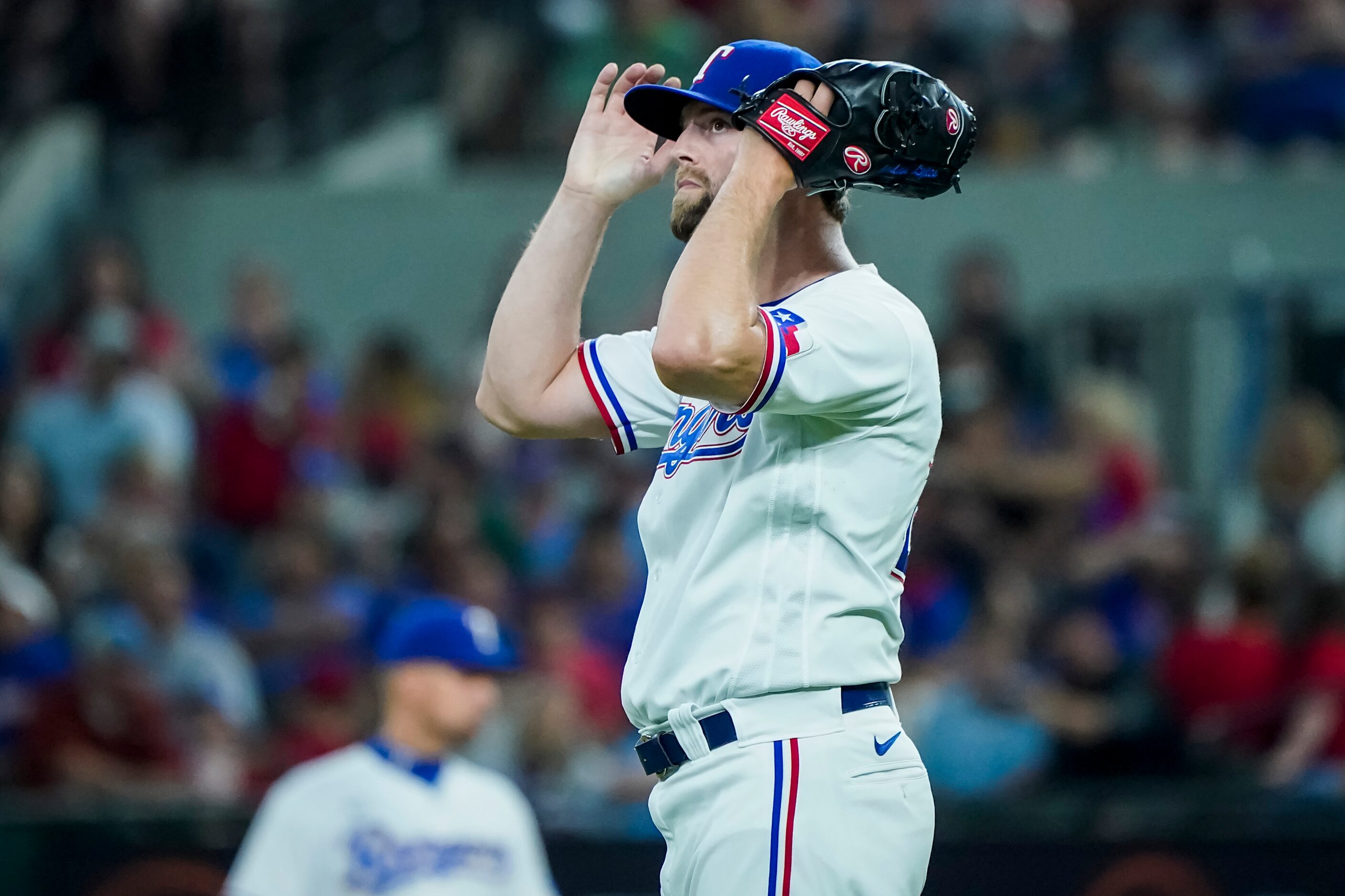 Texas Rangers starting pitcher Jordan Lyles reacts after giving up a home run to Boston Red...