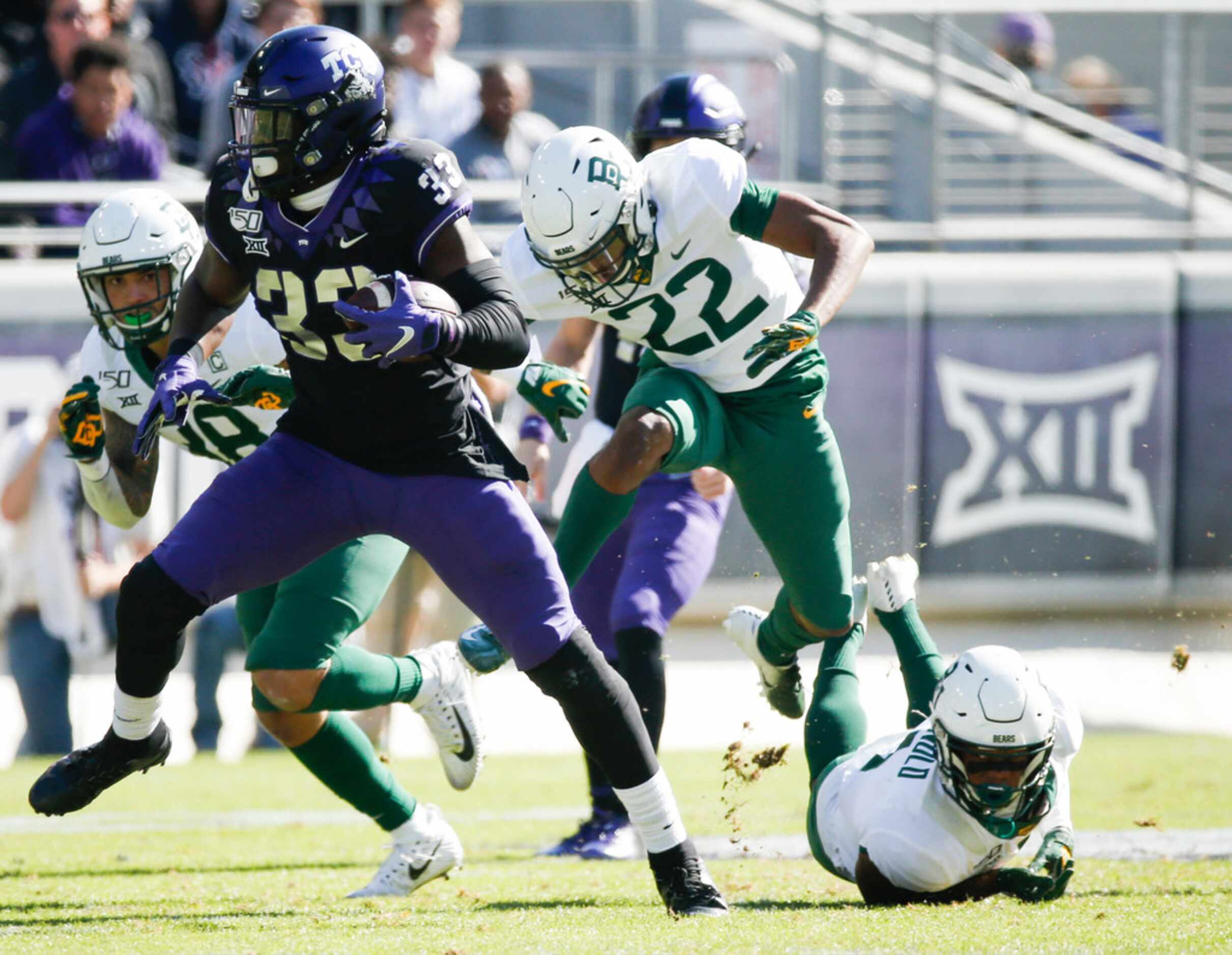 TCU Horned Frogs running back Sewo Olonilua (33) runs a lane past Baylor Bears linebacker...