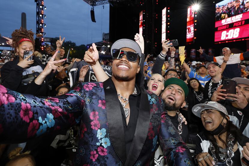 Texas Tech edge Tyree Wilson poses with Las Vegas Raiders fans after being selected with the...