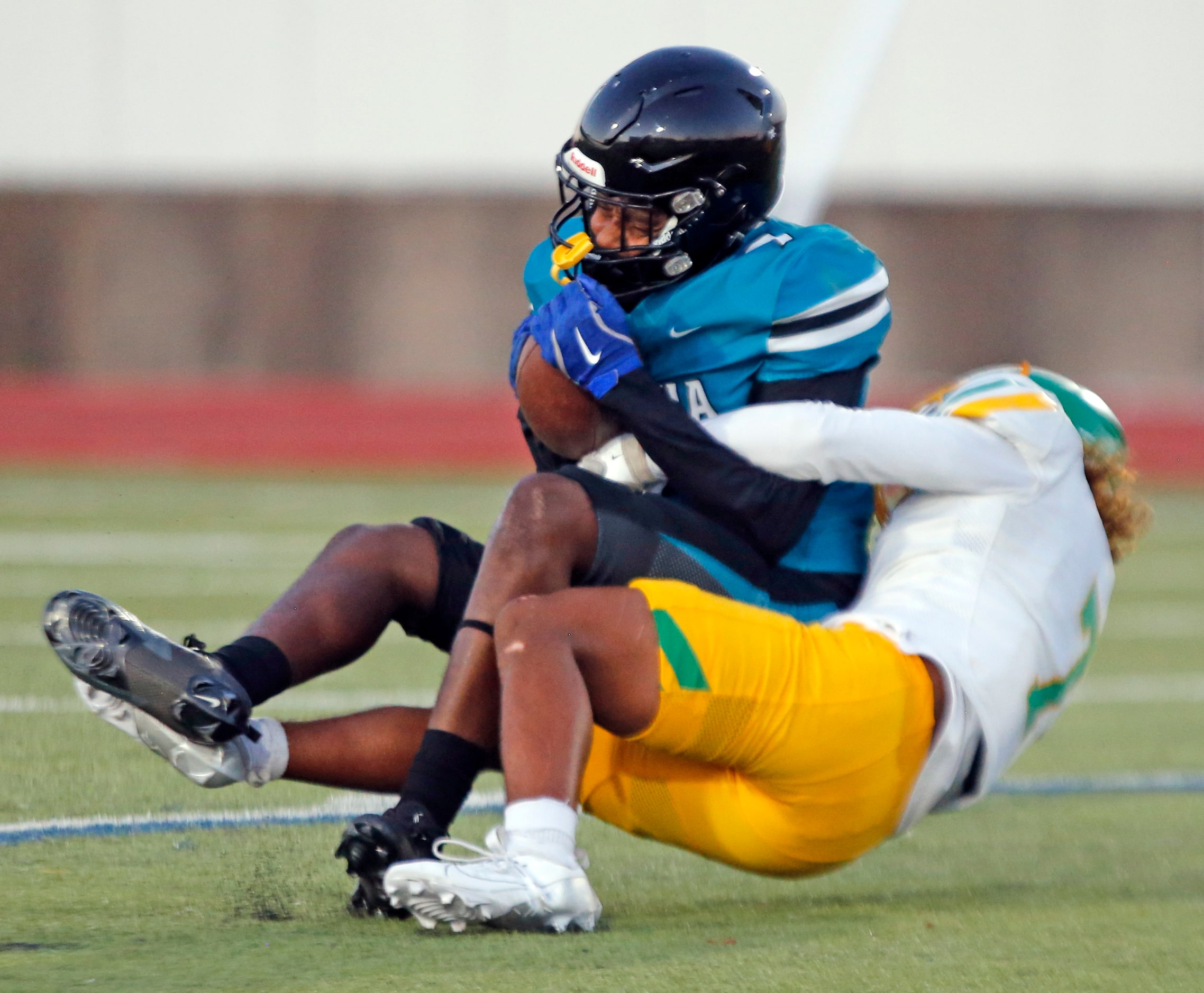 Molina High’s Kingston Chavez (7) is tackled by Carrollton Newman Smith High defender Allen...