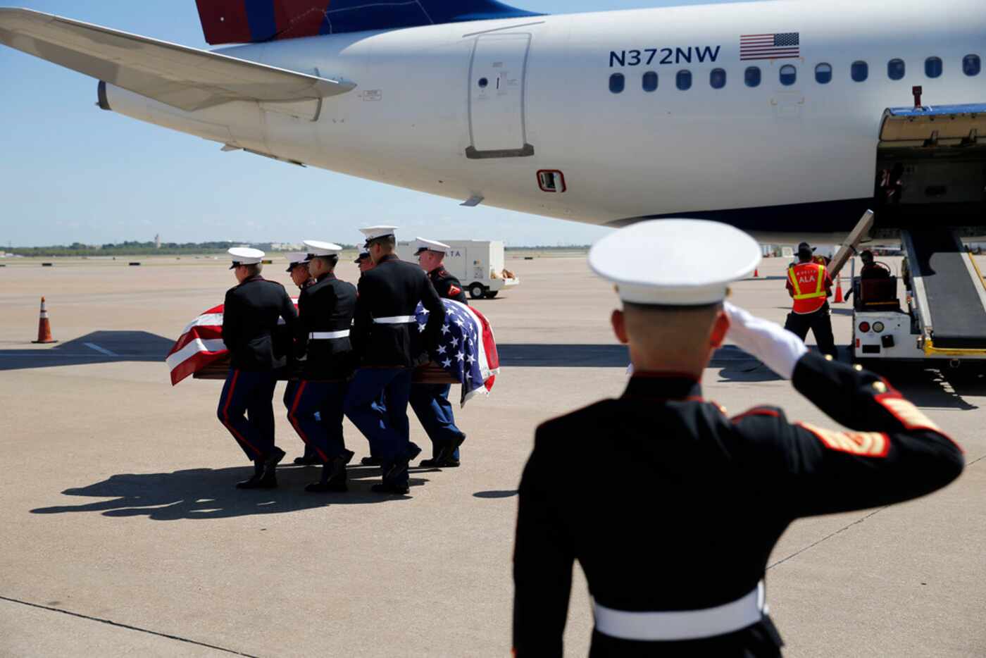 Marines carry the remains of Marine Corps  Pfc. Grady J. Crawford at DFW international...