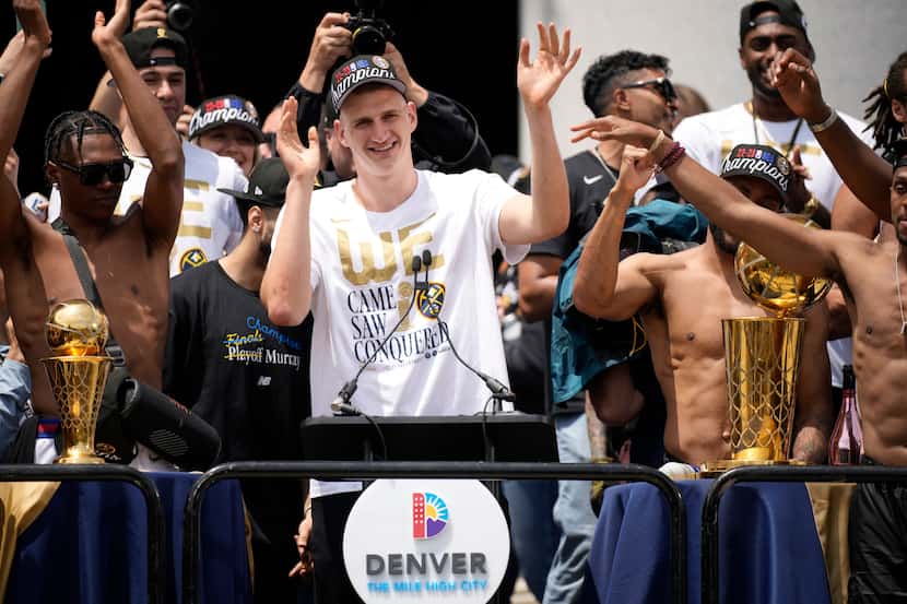 Denver Nuggets center Nikola Jokic celebrates during a rally and parade to mark the team's...