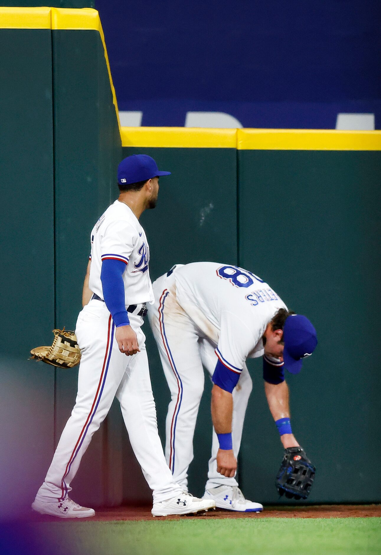 Texas Rangers left fielder Jason Martin (left) and center fielder DJ Peters react after both...