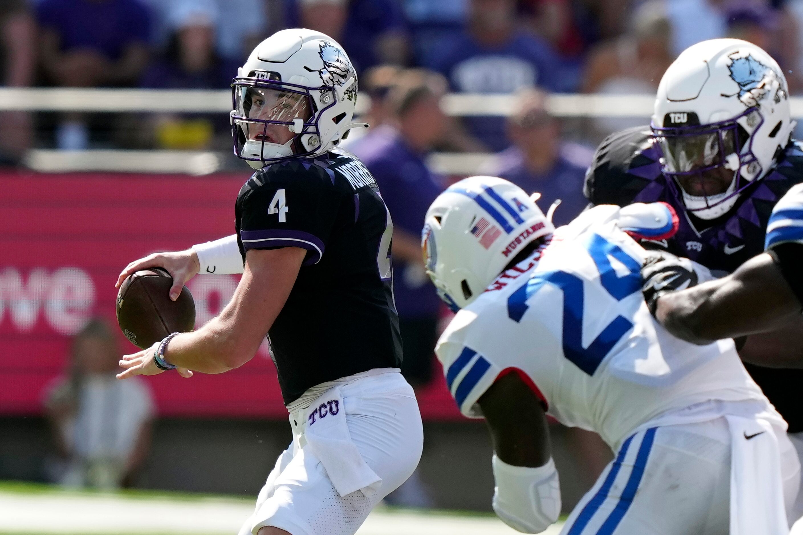 TCU quarterback Chandler Morris (4) looks to pass as SMU linebacker Kobe Wilson (24) is...