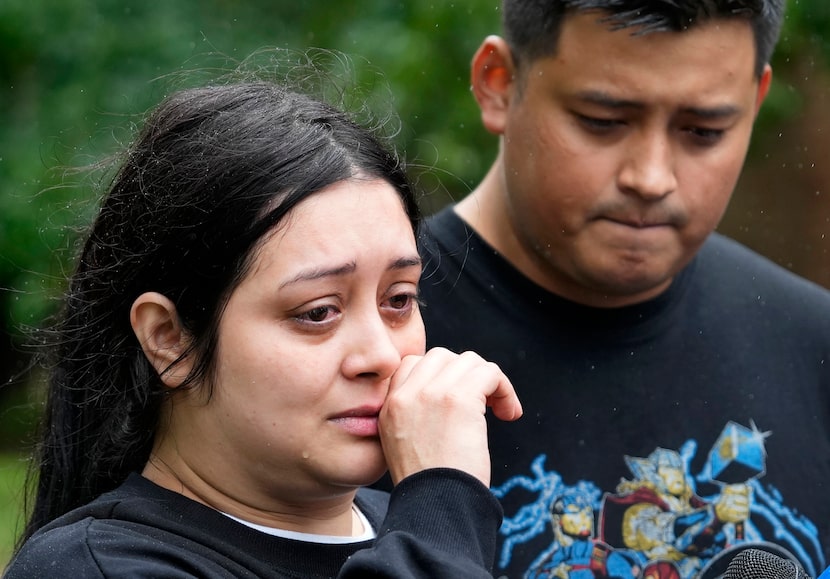 Haley Loredo with her brother, Elmer Alvarado, wipes away tears outside her home in the...