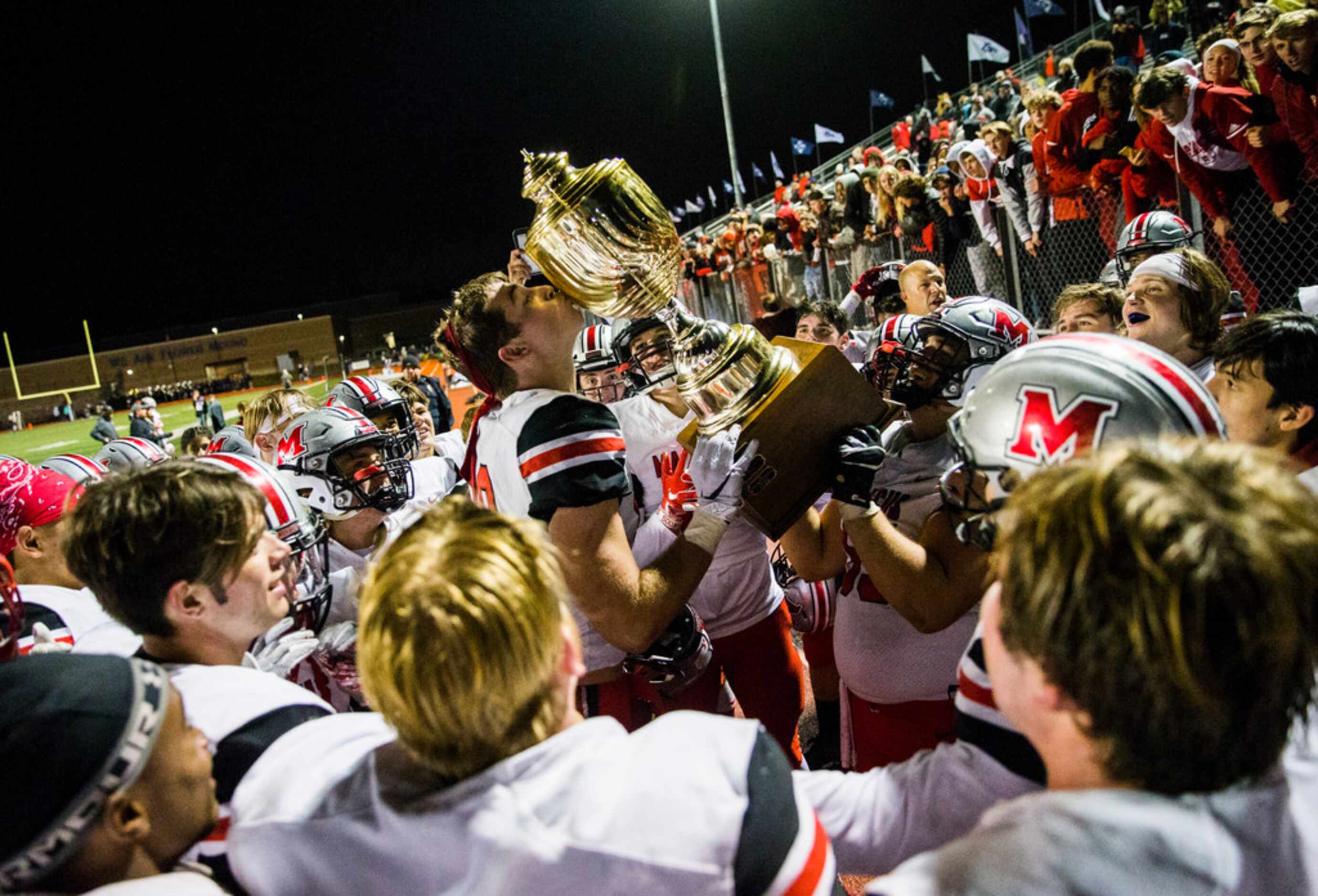 Flower Mound Marcus hoists the Mound Showdown trophy after a 34-31 win over Flower Mound on...