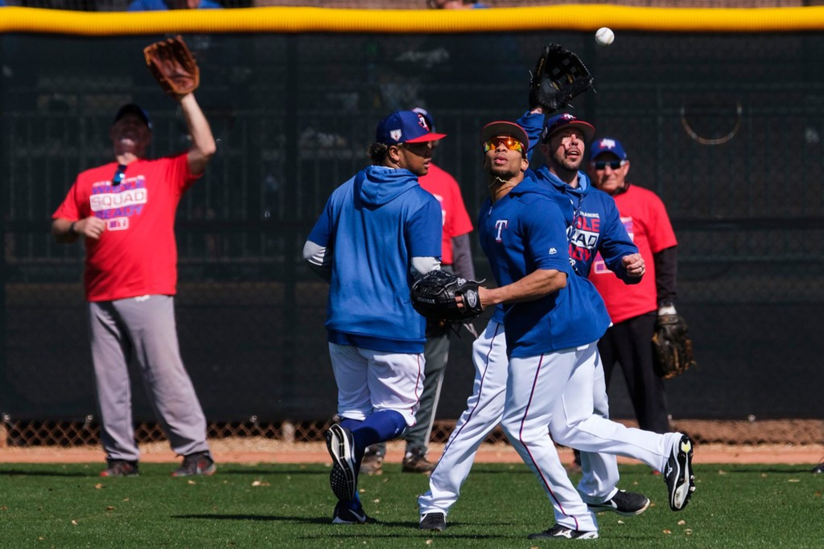 Texas Rangers outfielder Ben Revere (front), outfielder Willie Calhoun (left) and major...