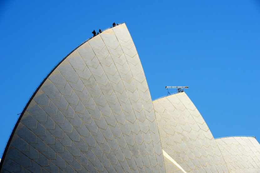 Workers install lights on the sails of the Sydney Opera House ahead of the upcoming Vivid...