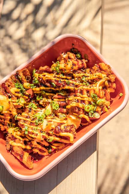 Yummy Fries at Palma are sweet potato waffle fries topped with spicy aioli, truffle yuzu and...