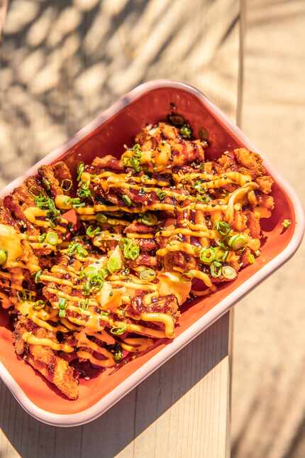 Yummy Fries at Palma are sweet potato waffle fries topped with spicy aioli, truffle yuzu and...