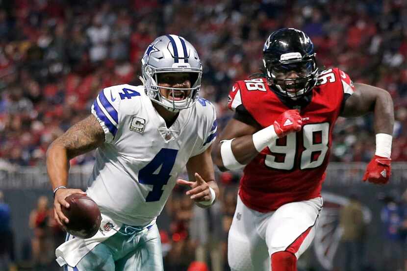Dallas Cowboys quarterback Dak Prescott (4) races for a first quarter touchdown as he is...