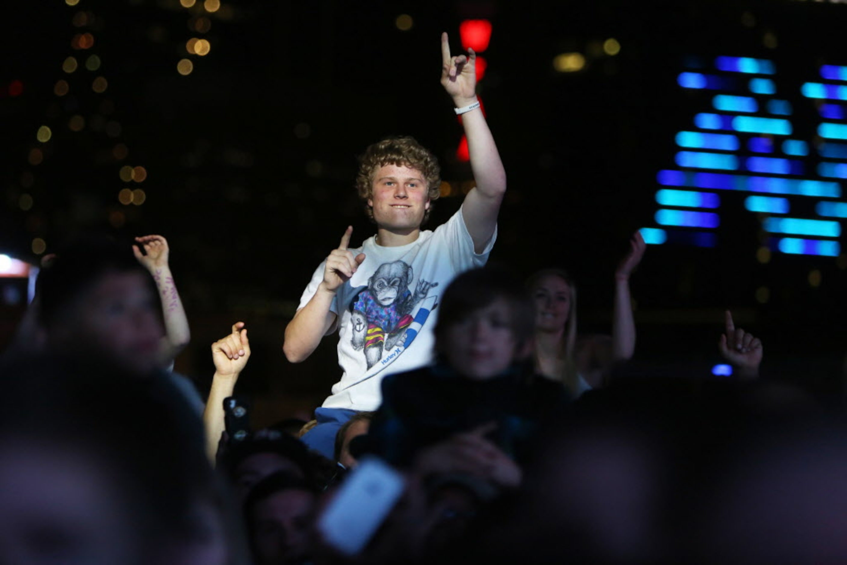 Fans cheer as they listen to Jason Aldean live onstage at the 2014 NCAA March Madness Music...